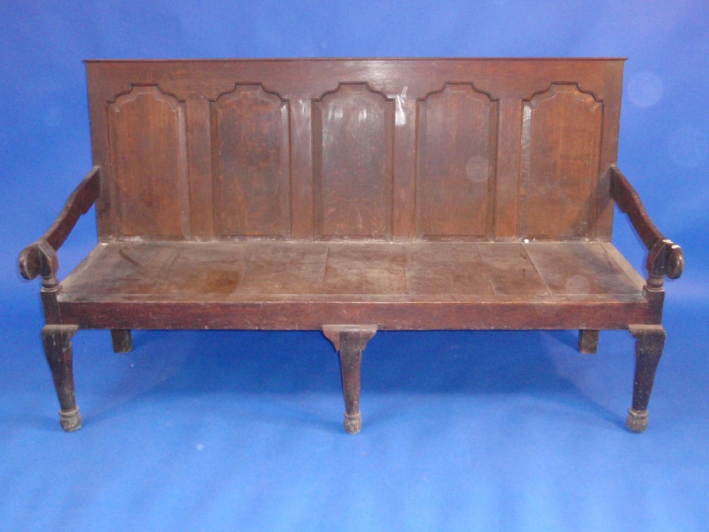 Appraisal: An th century oak settle with five fielded arch panels