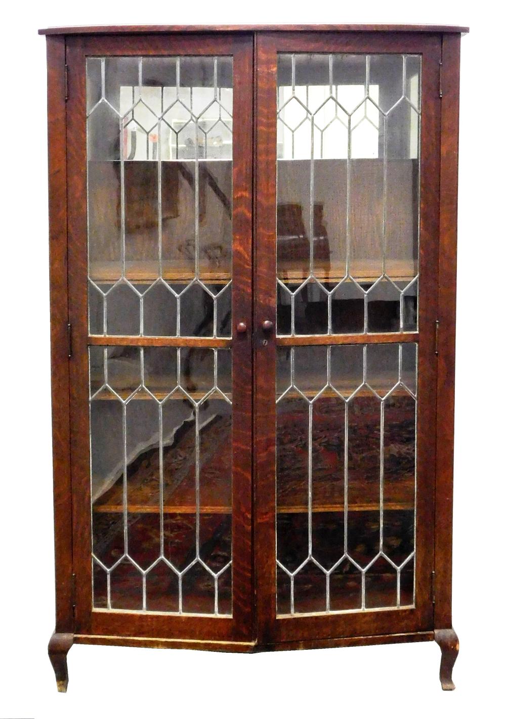 Appraisal: Bookcase oak with leaded glass panel doors bow front with