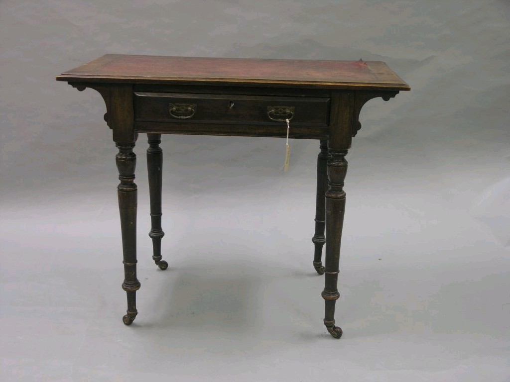 Appraisal: A late Victorian oak writing table with inset red leather