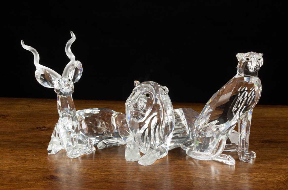 Appraisal: THREE SWAROVSKI CRYSTAL KUDU LION AND CHEETAH FIGURINES designed by