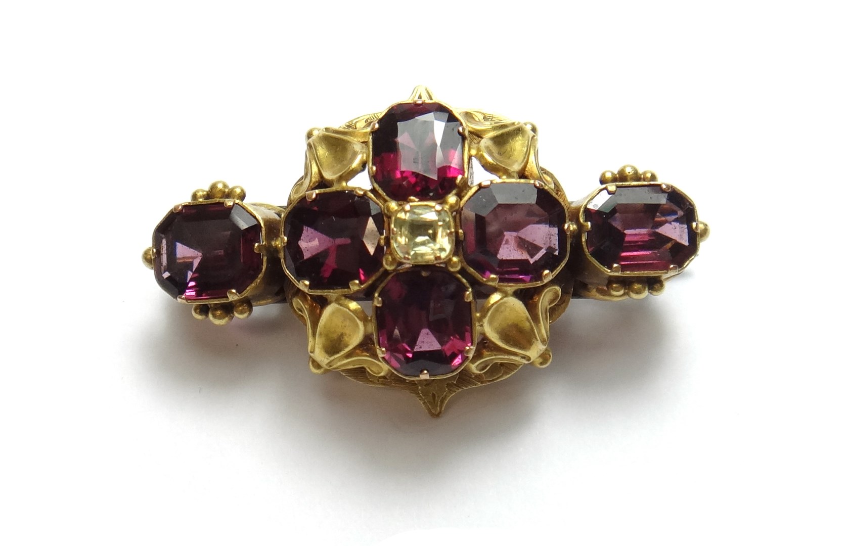 Appraisal: A gold garnet and chrysolite set brooch decorated with four