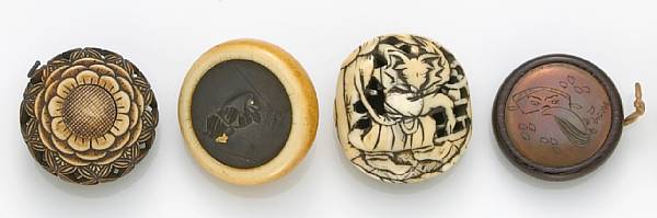 Appraisal: Four manju netsuke The first a stained ivory manju netsuke