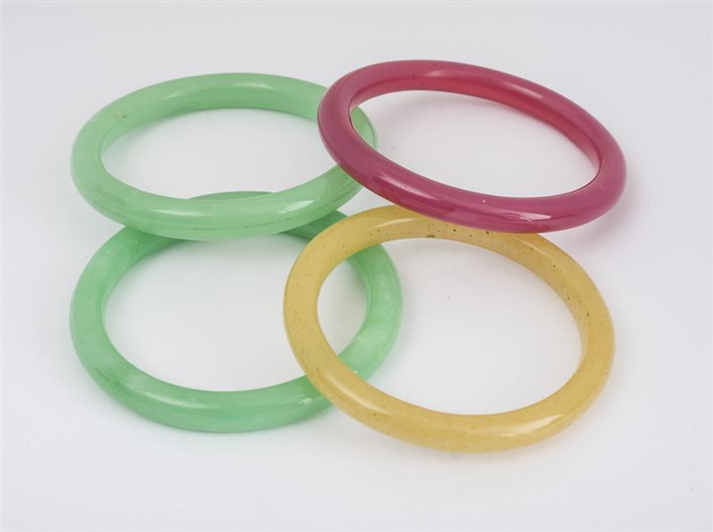 Appraisal: Four Vintage Peking Glass Bangles In green yellow and pink