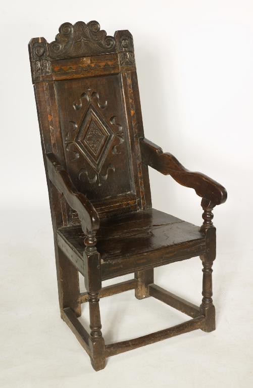 Appraisal: th CENTURY OAK OPEN ARMCHAIR with scroll-carved crest lozenge-carved back