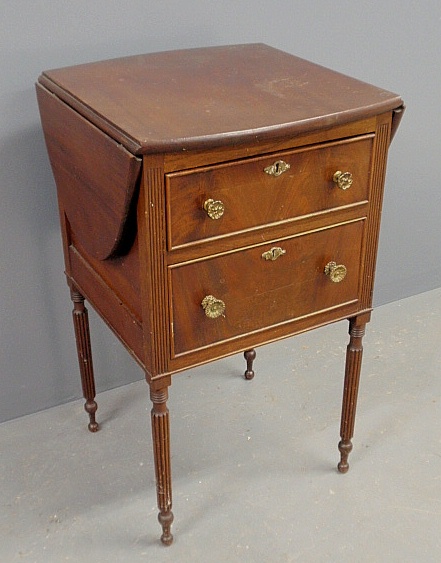 Appraisal: - Sheraton style mahogany two-drawer side table with drop leaves