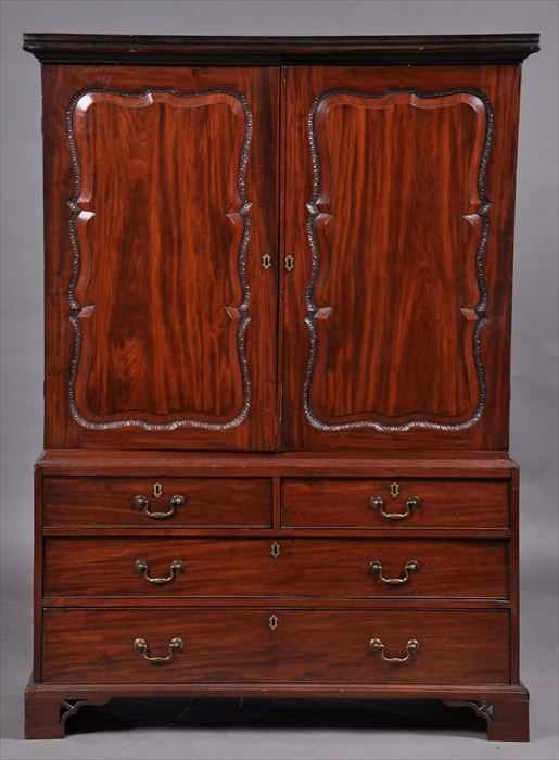 Appraisal: GEORGE II BRASS-MOUNTED CARVED MAHOGANY TWO-PART LINEN PRESS The molded