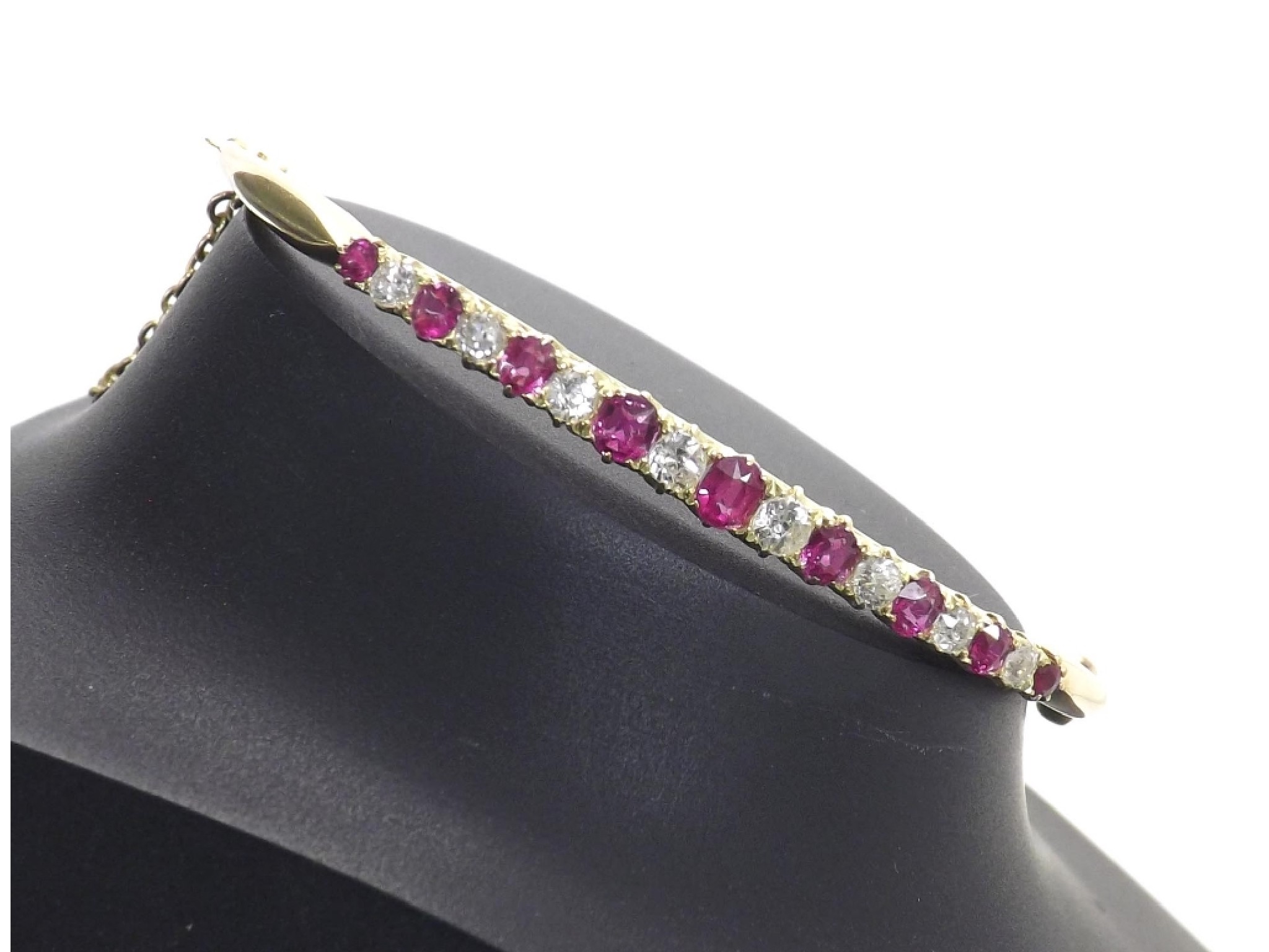 Appraisal: Early th century graduated ruby and diamond hinged bangle with