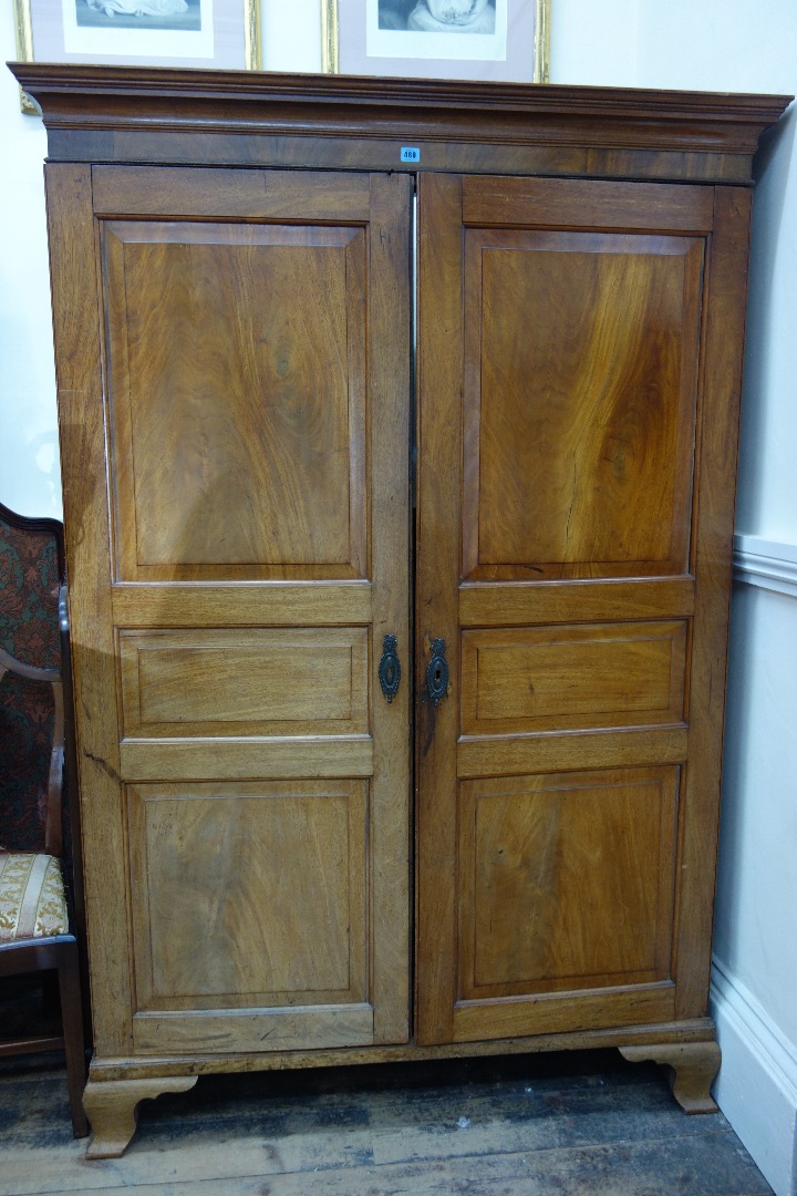 Appraisal: A George III mahogany Channel Islands wardrobe of panelled construction