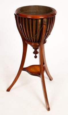 Appraisal: An Edwardian mahogany slatted jardini re on splay legs united