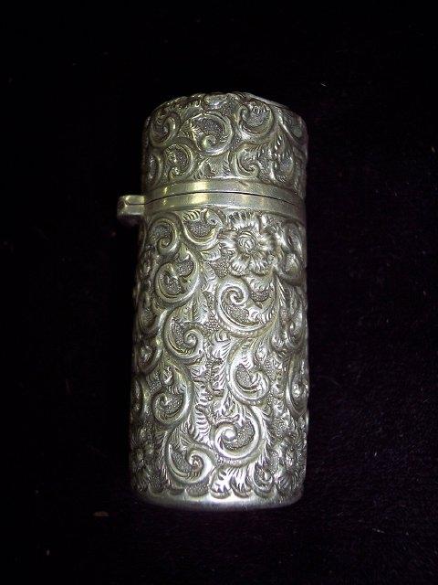 Appraisal: A silver cased scent bottle scrolling foliate decoration throughout G