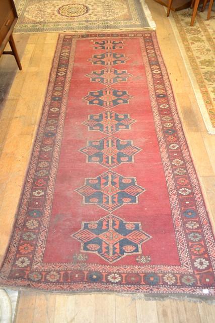 Appraisal: A LARGE PERSIAN RUNNER IN DARK RED AND BROWN TONES