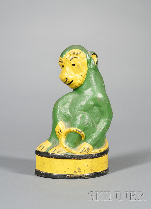 Appraisal: Painted Cast Iron Monkey on Barrel Doorstop America c the