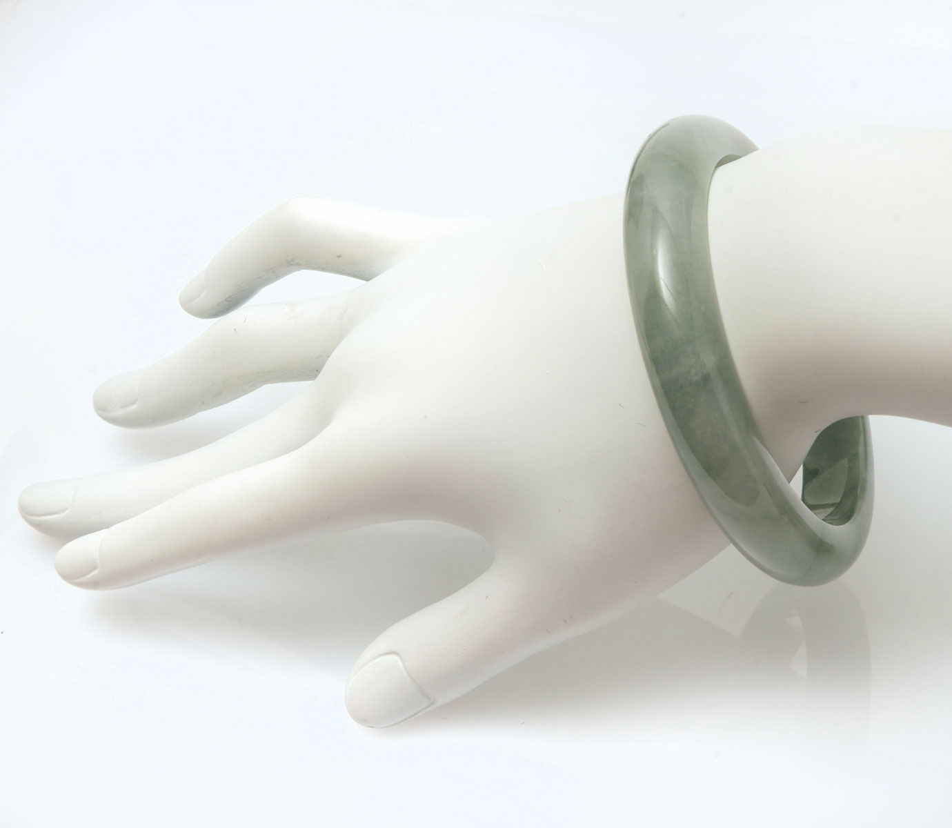 Appraisal: JADE BANGLE BRACELET Really lovely soft green tones Measures inside