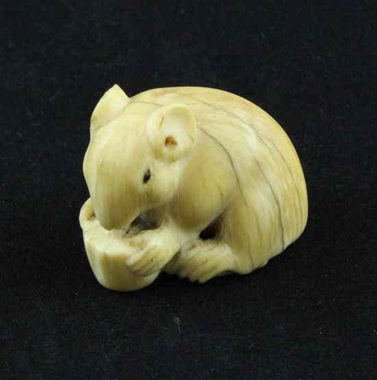 Appraisal: An Edo period ivory netsuke carved as a rat eating