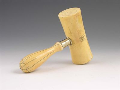 Appraisal: A Victorian turned ivory gavel with an engraved monogram 'MEA'