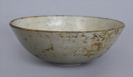 Appraisal: CHINESE RELIEF-DECORATED IVORY-GLAZED PORCELAIN FOOTED BOWL Probably Sung the interior