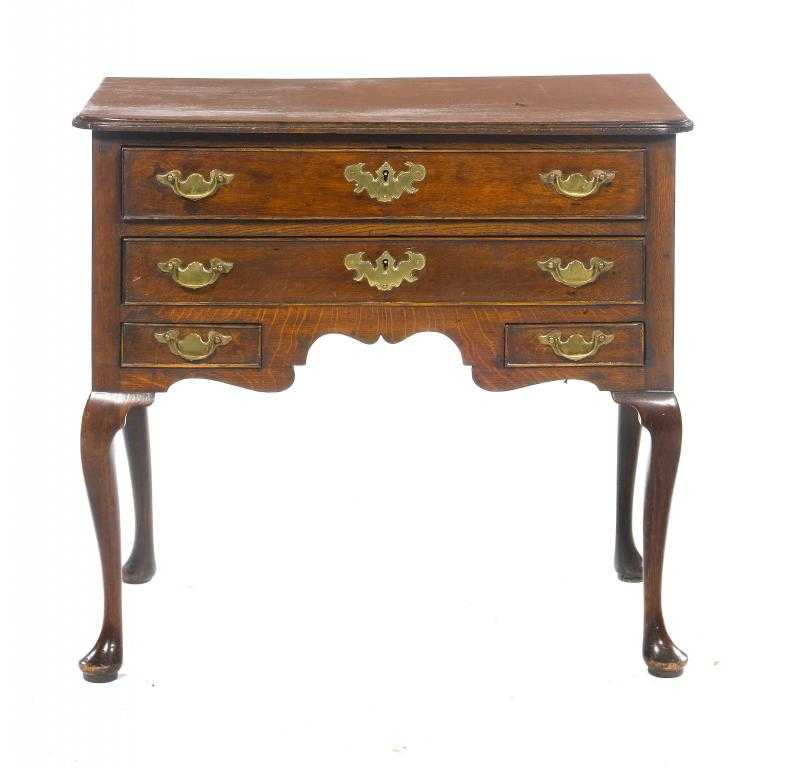 Appraisal: A GEORGE III OAK LOWBOY fitted with two beaded drawers