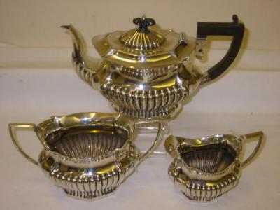 Appraisal: AN EDWARDIAN THREE PIECE TEA SET of half fluted shaped