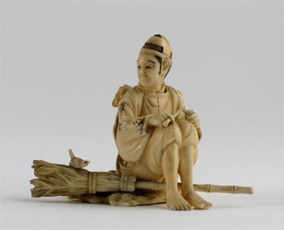 Appraisal: A Japanese ivory carving of a seated man smoking a