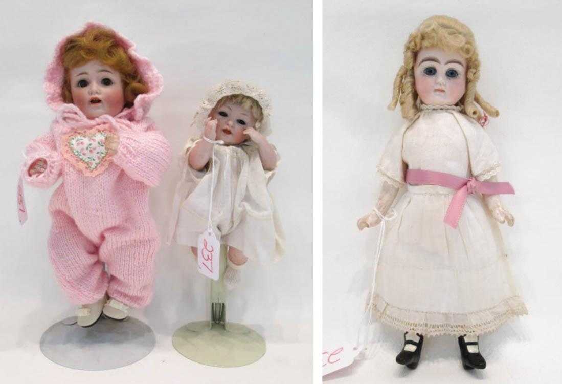 Appraisal: THREE BISQUE HEAD DOLLS the first wearing pink marked Made