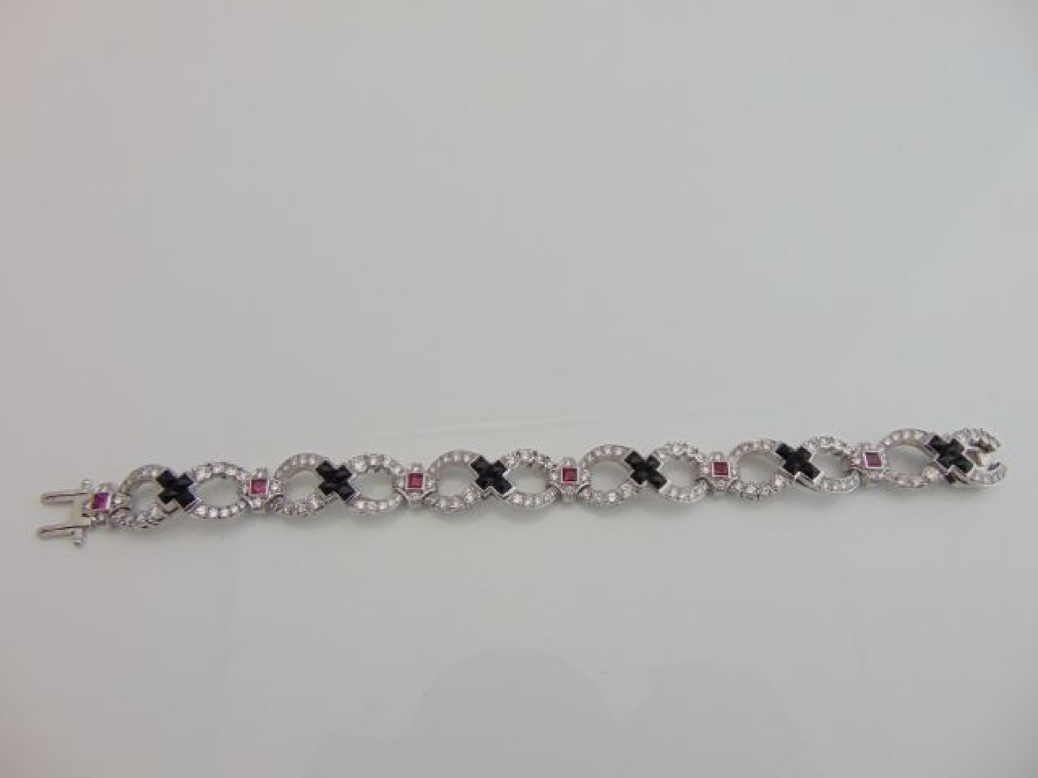 Appraisal: A diamond onyx and ruby bracelet Tiffany Co composed of