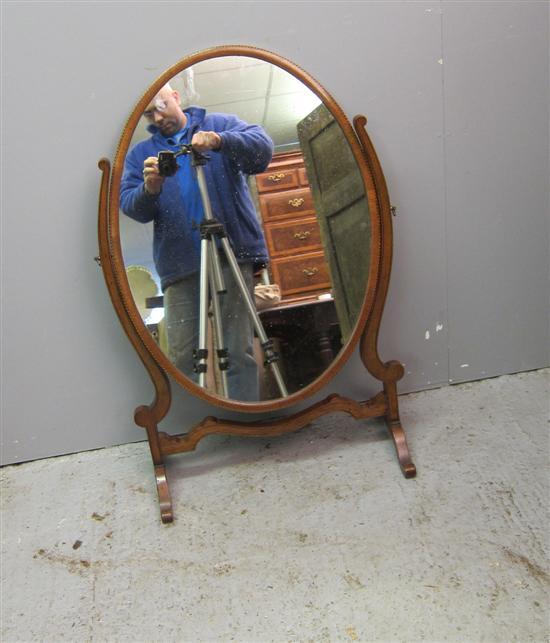 Appraisal: Early twentieth century mahogany oval bedroom mirror on splayed legs