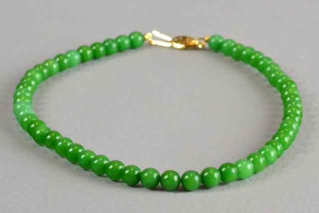 Appraisal: Chinese Spinach Jade Bead NecklaceComprising fifty three circular beads with