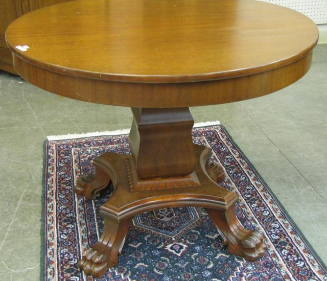 Appraisal: Antique mahogany round table with paw foot pedestal nice condition