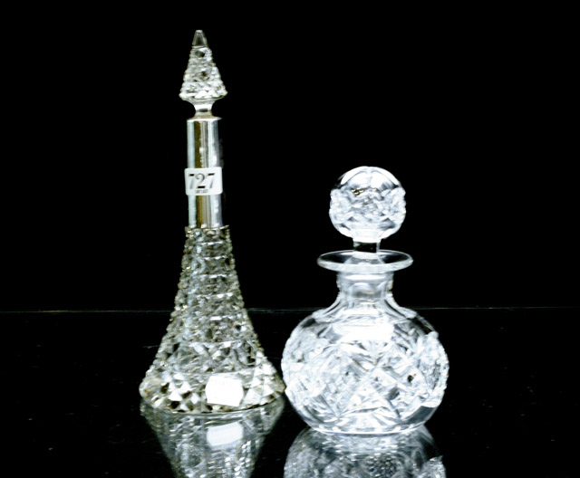 Appraisal: A Victorian silver mounted scent bottle with another crystal bottle