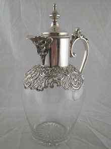 Appraisal: A late Victorian silver mounted claret jug with lion's head