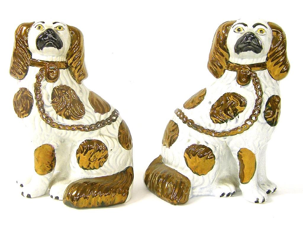 Appraisal: Pair of Staffordshire seated spaniels with rough coats and copper