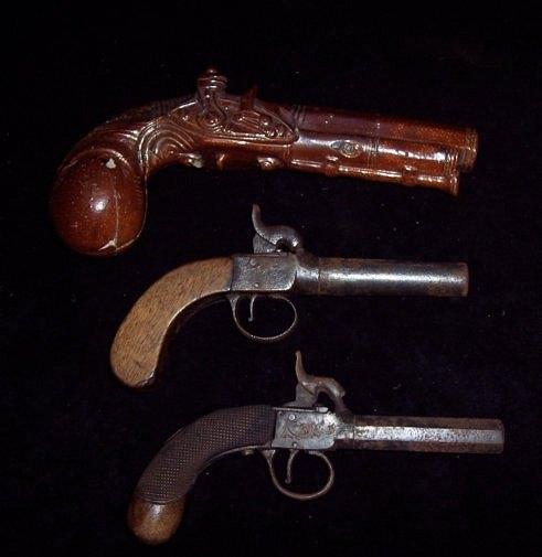 Appraisal: Two percussion cap pistols with walnut grips and screw-off barrels