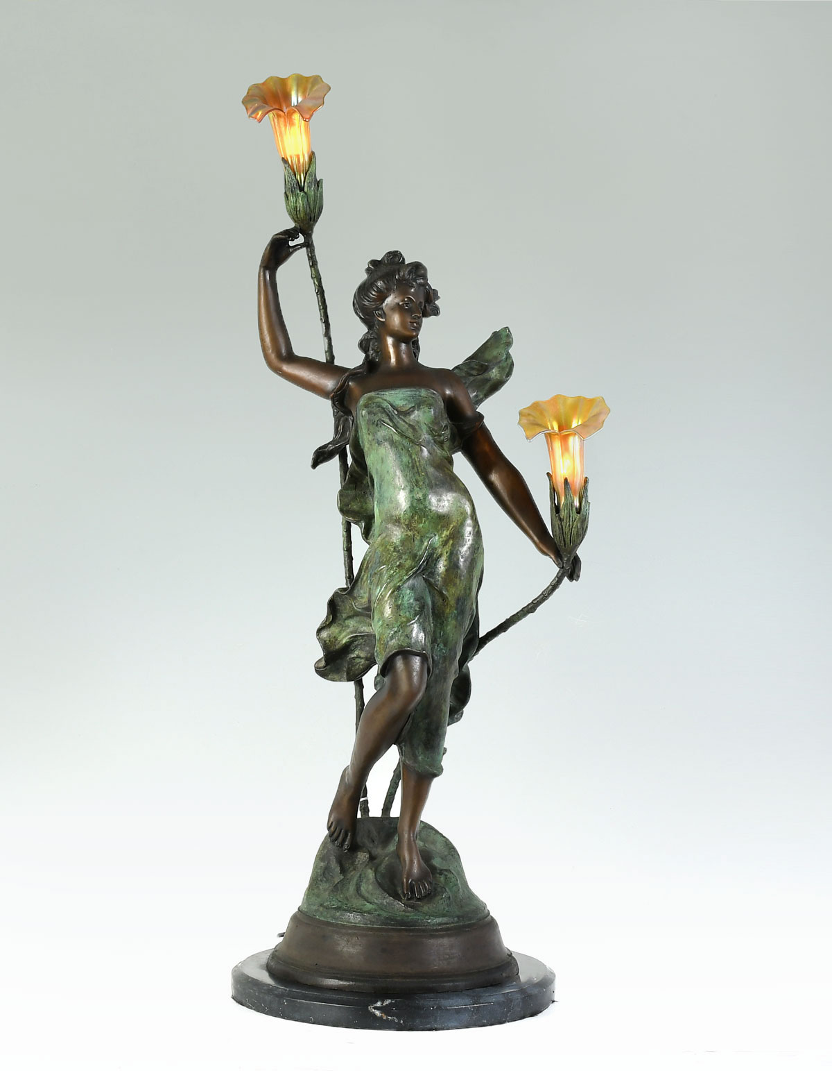 Appraisal: PATINATED BRONZE FEMALE SCULPTURE LAMP WITH ART GLASS SHADES Two