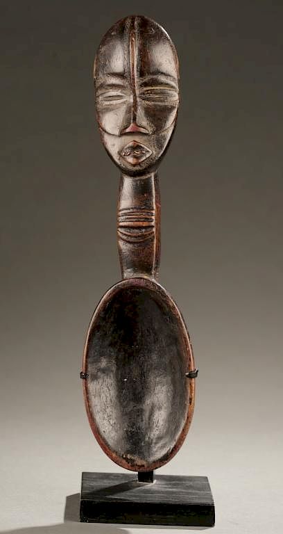 Appraisal: Dan ladle with carved human head A ladle with a