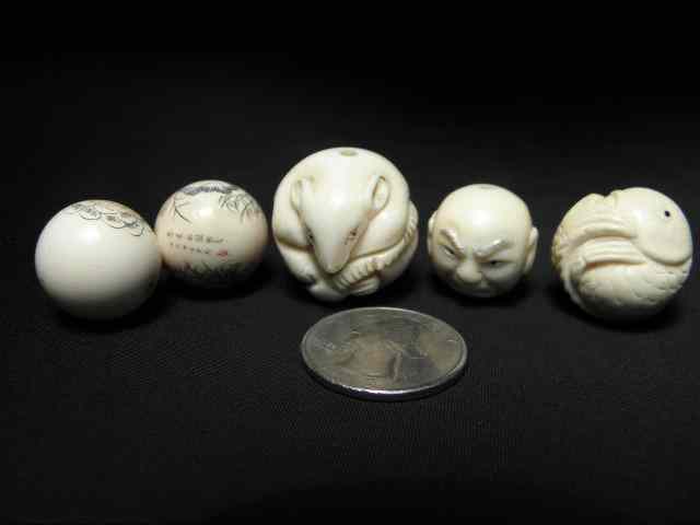 Appraisal: Five Oriental carved ivory figural netsuke beads Includes a carved