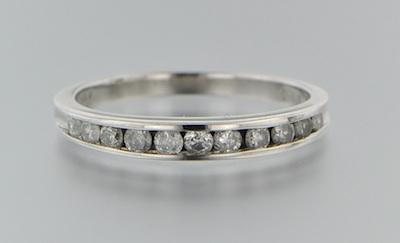 Appraisal: A Platinum and Diamond Band platinum band features a row