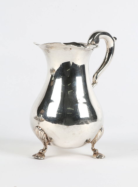 Appraisal: A GEORGE II SILVER CREAM JUG of baluster form with