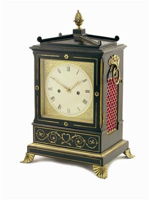 Appraisal: A Regency ebonised and brass mounted mantel clock the twin