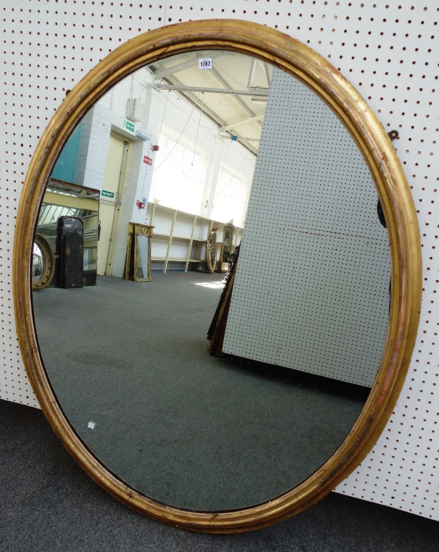 Appraisal: A large Victorian gilt framed oval wall mirror with moulded