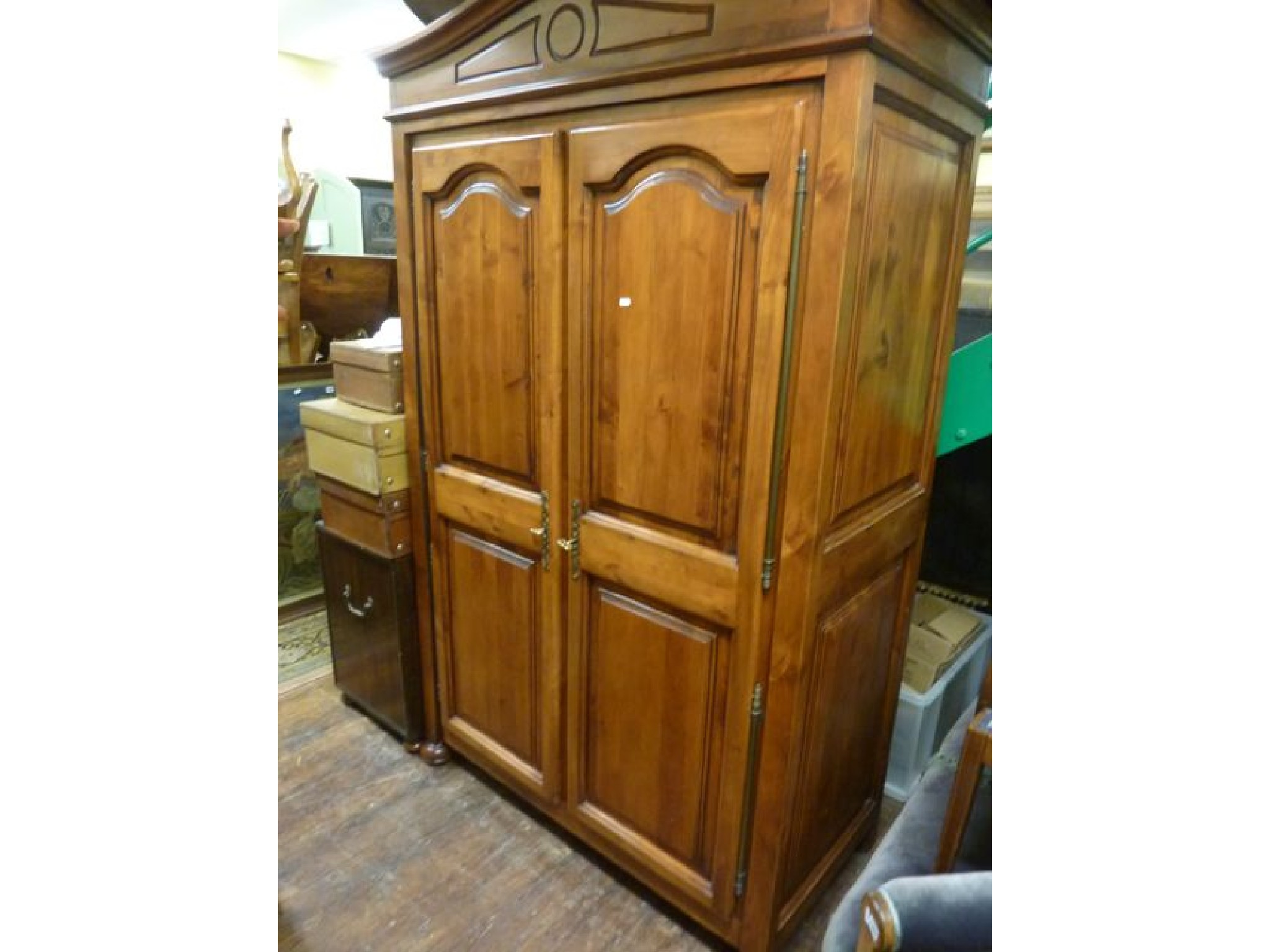 Appraisal: A reproduction continental wardrobe enclosed by two panelled doors with