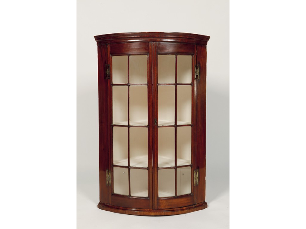 Appraisal: A GEORGE III MAHOGANY HANGING BOWFRONTED CORNER CUPBOARD with twin