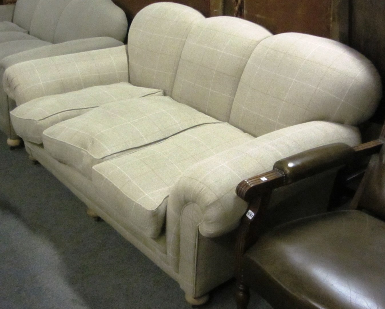 Appraisal: A mid th century light tweed upholstered triple hump-backed sofa