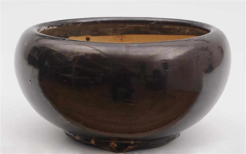 Appraisal: CHINESE UMBER-GLAZED POTTERY BOWL The squat spherical form with inverted