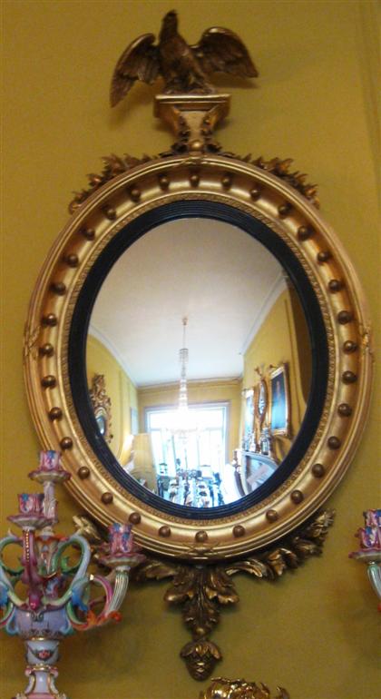 Appraisal: Classical style carved giltwood oval convex mirrorlate th century