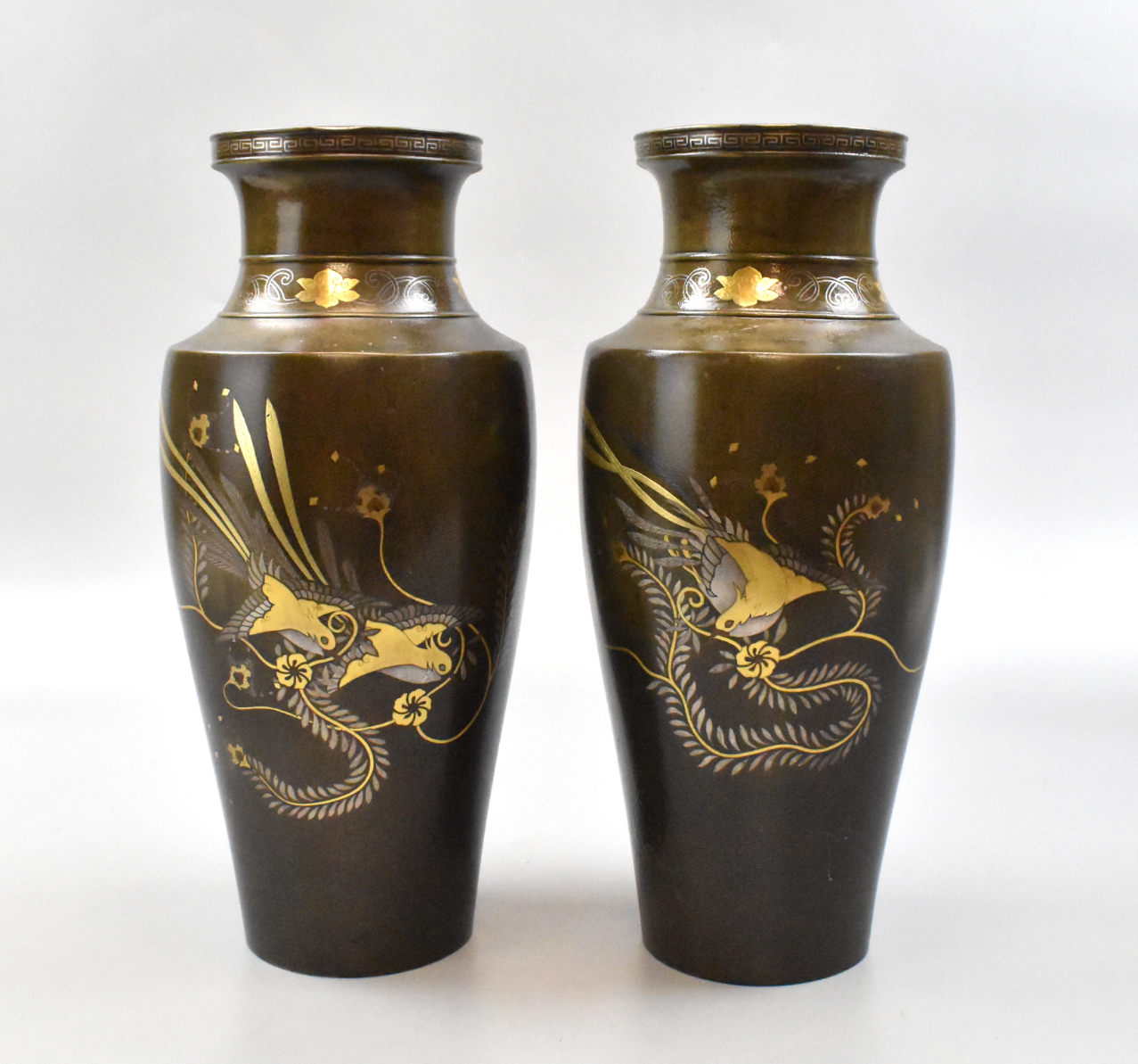 Appraisal: A pair of Japanese mixed metal vases Each vase features