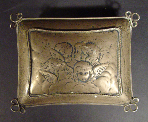 Appraisal: Edwardian silver cushion shaped box the lid embossed with cherubs