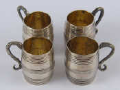 Appraisal: A set of four barrel shaped silver tots with snake