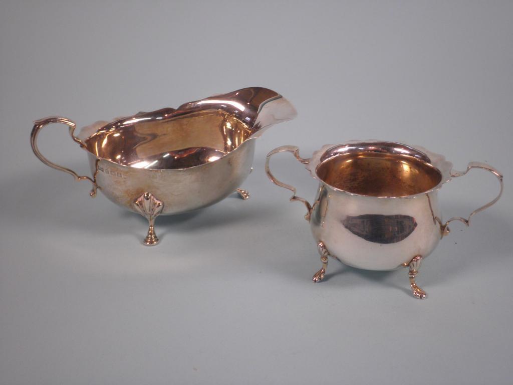 Appraisal: A silver two-handled sugar bowl on four shaped feet cm