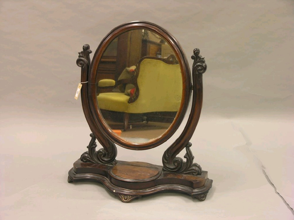 Appraisal: A Victorian mahogany dressing mirror oval mirror adjustable upon carved