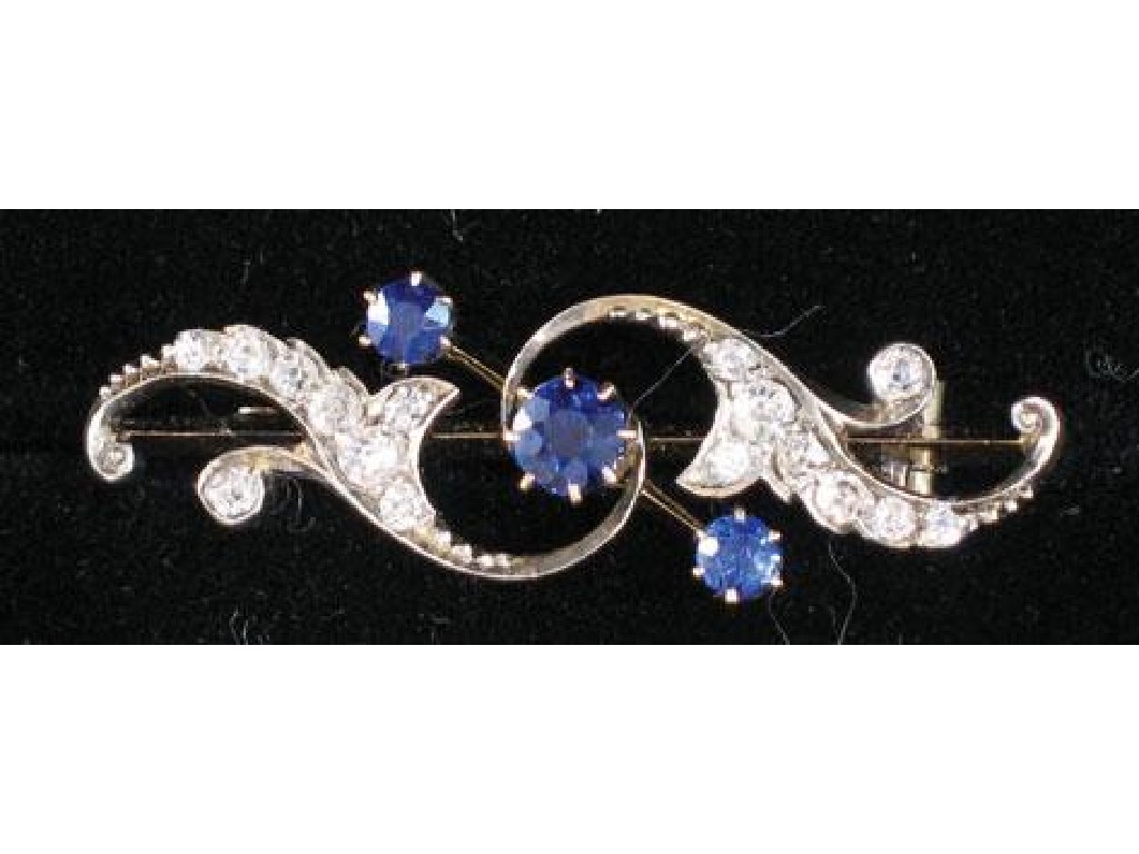 Appraisal: A SAPPHIRE AND DIAMOND OPEN-WORK BROOCH the scrolling foliate mount